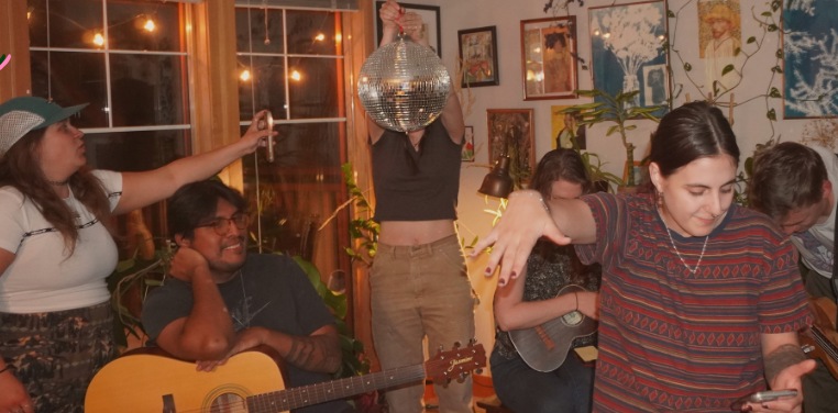A gathering with music and a disco ball in Amal’s kitchen