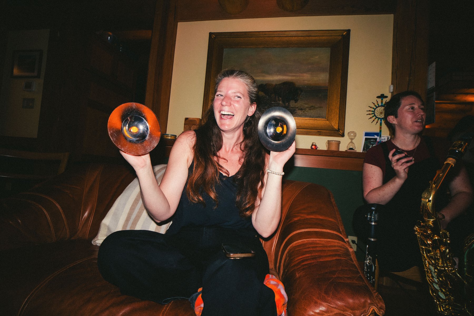 A participant playing shakers at a jam night